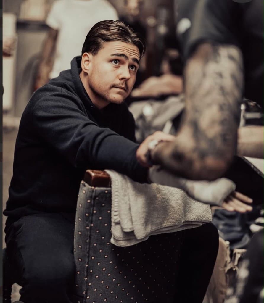 Billy from Essex, TTS ambassador, having his hands wrapped before boxing training in a gym.
