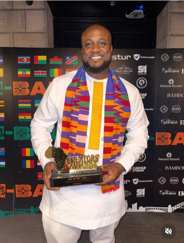 SEN Bytes founder holding the DEI Creator of the Year 2024 Afriball award trophy